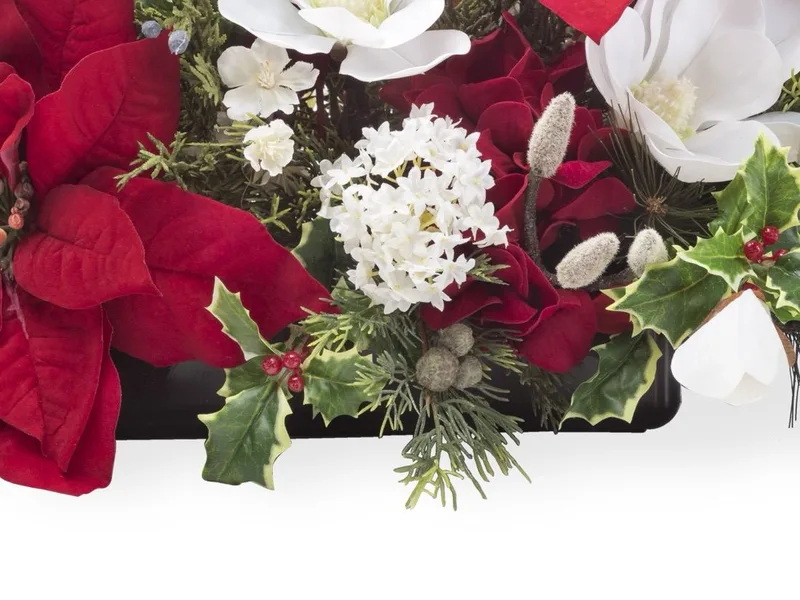 Weighted florist container tucked under variegated holly, cedar and white blooms