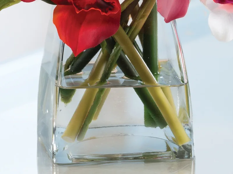 Heavy glass tapered cube vase filled with crystal-clear acrylic water