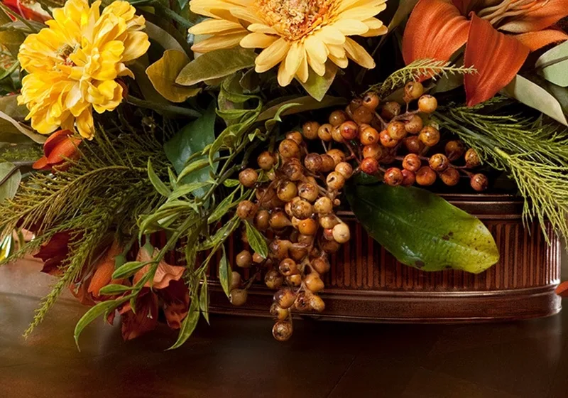 Ribbed oval metal planter in aged brown with berries spilling over the rim