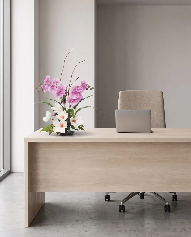 Magnolias and Orchids silk flower arrangement on a reception desk
