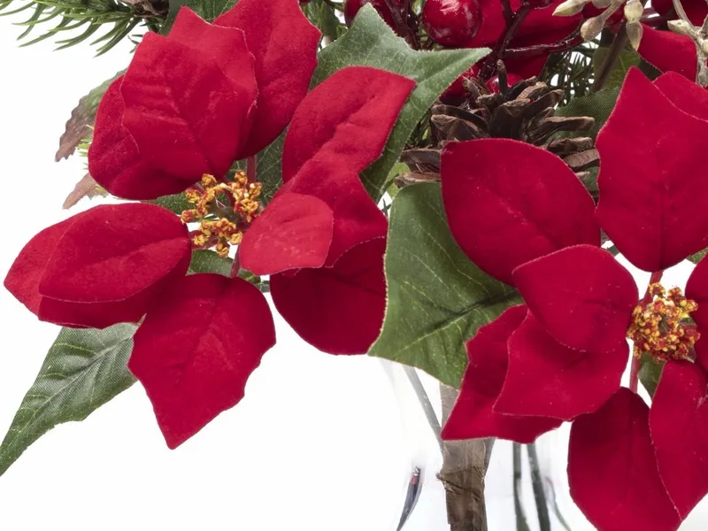 Macro close-up of a red silk poinsettia bloom with velvety petals