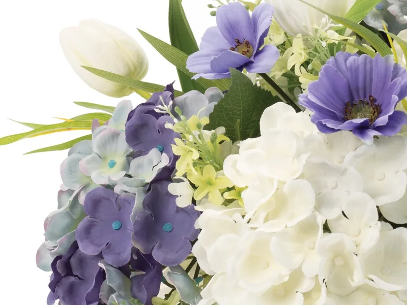 White silk tulip and spring green lilac sprigs among the hydrangeas