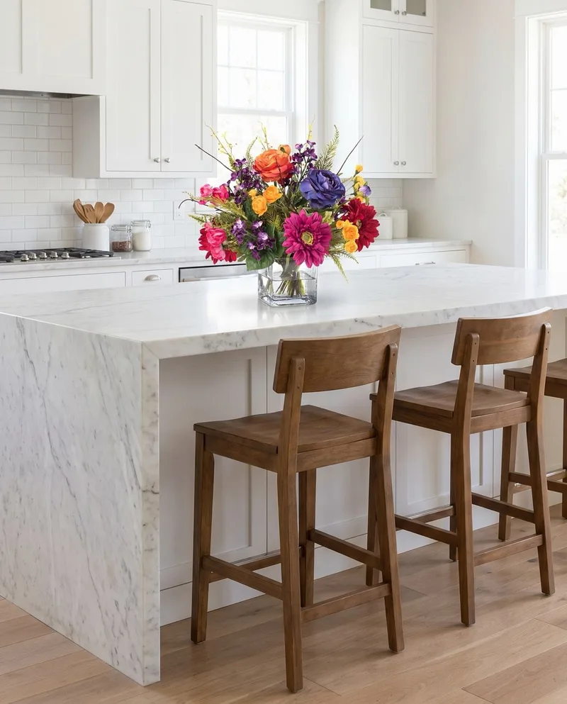 Festive Mood silk flower centerpiece on a white marble kitchen island with wooden bar stools