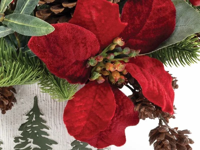 Macro close-up of a red velvet silk poinsettia bloom with a beaded centre