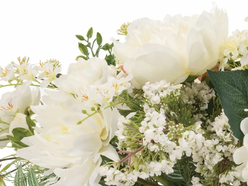 Close-up of a white silk dahlia beside full white peonies
