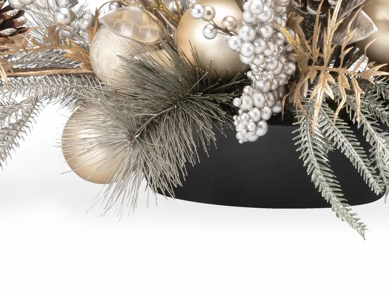 The low oval resin planter under the frosted greenery
