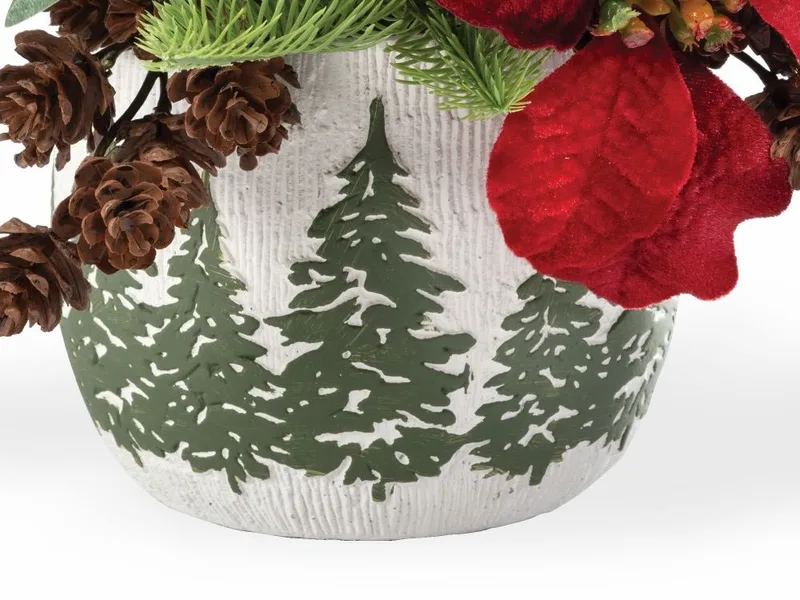 Close-up of the green trees motif on the white pot, ringed with cones
