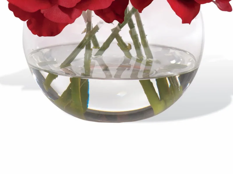 Glass ball vase with crystal-clear acrylic water around red rose stems