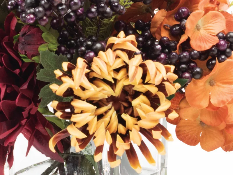 Macro close-up of a golden yellow silk spider mum with a dark center