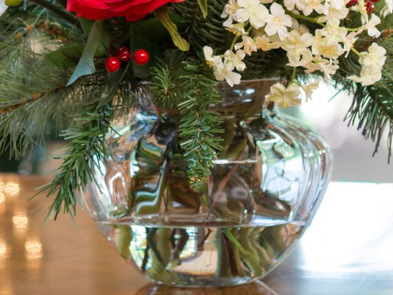 Glass ball vase filled with crystal-clear acrylic water around the stems