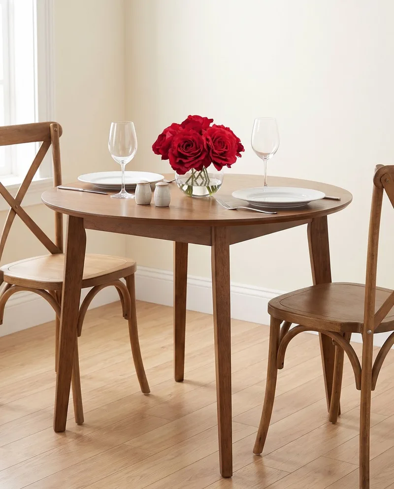 Rose Nosegay silk flower arrangement in Red on a dining table set with place settings