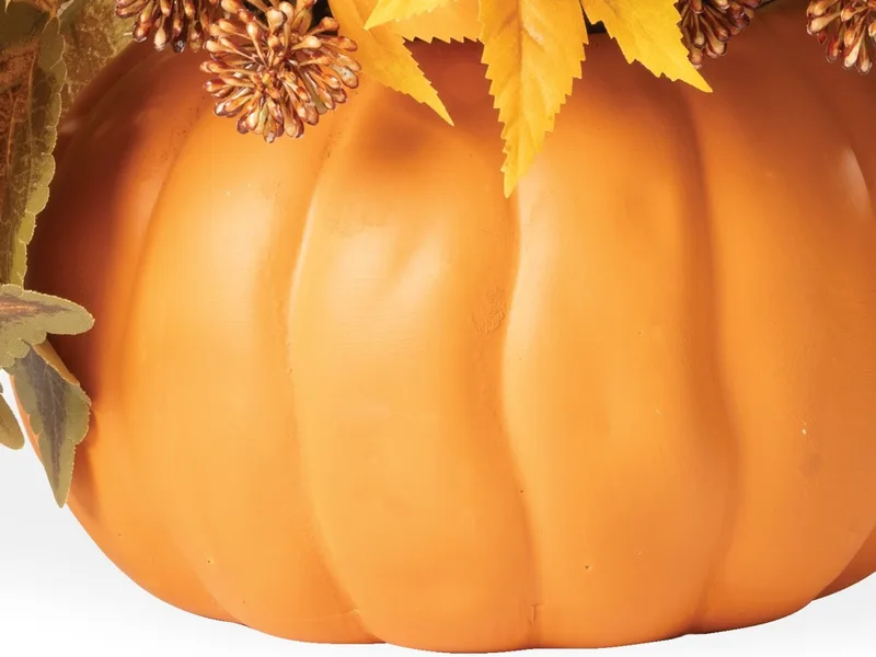 Hand-glazed ceramic pumpkin planter close-up showing ribbed surface and warm color
